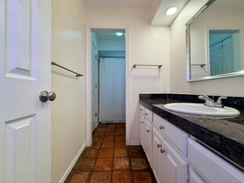 5045 Thunder Road Dallas, TX 75244 - Photo 20 of 28 a spacious bathroom with a granite countertop sink and a mirror