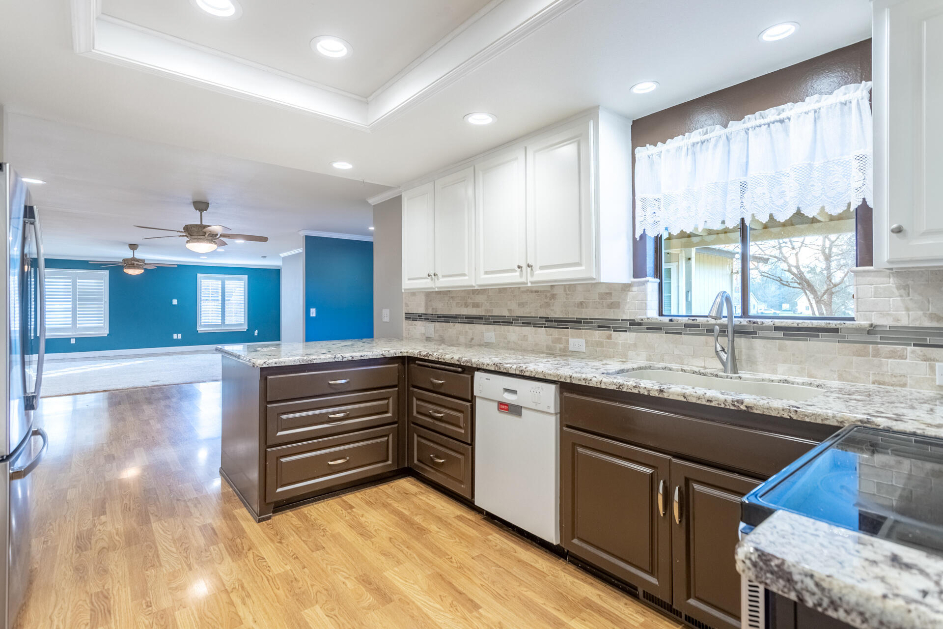 6766 Drake Drive Anderson, CA 96007 - Photo 23 of 44 a kitchen with kitchen island granite countertop a sink cabinets and window