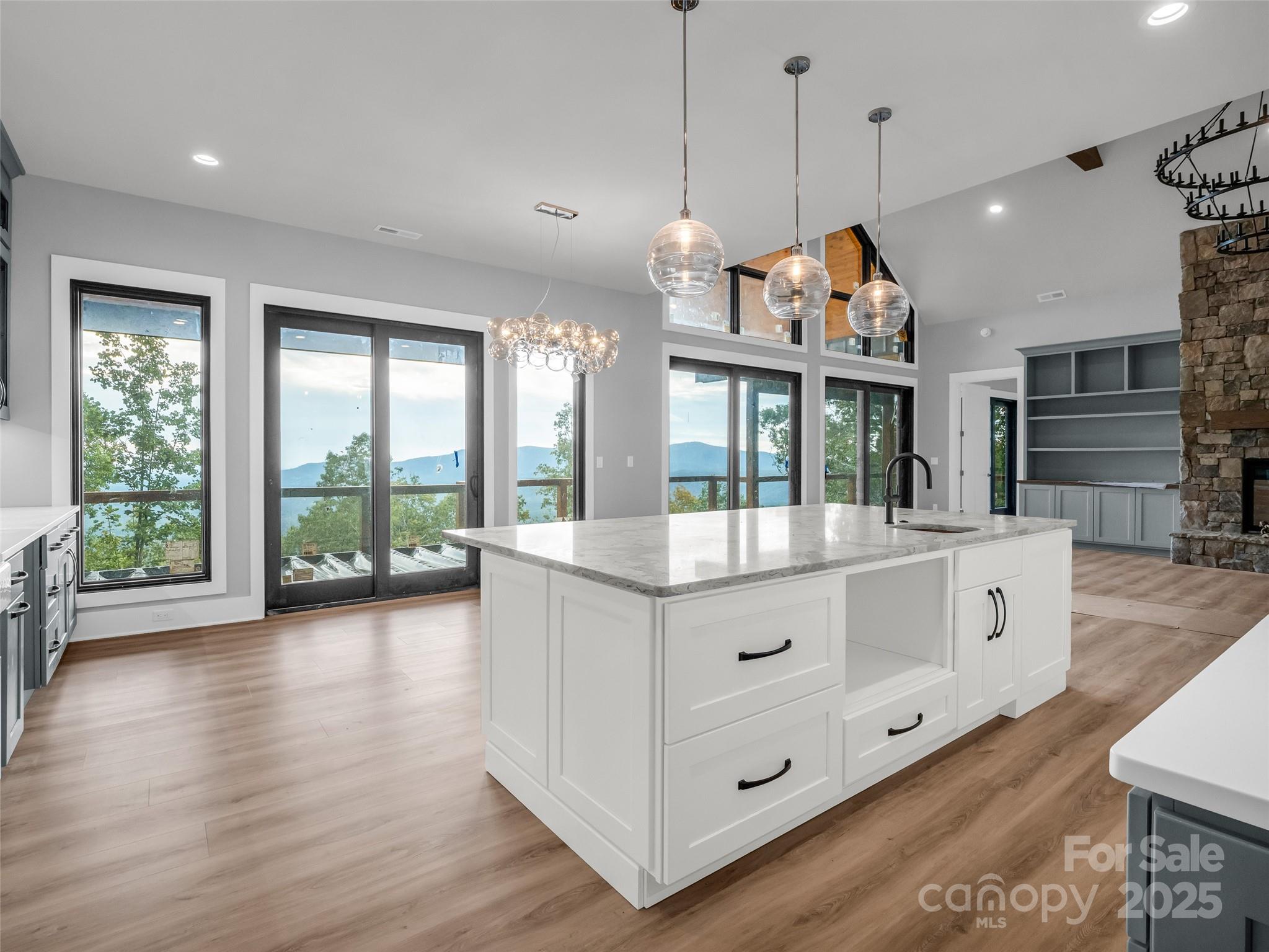 93 Chesterfield Drive Mill Spring, NC 28756 - Photo 11 of 48 a view of spacious kitchen with granite countertop a stove a sink a large window and wooden floor