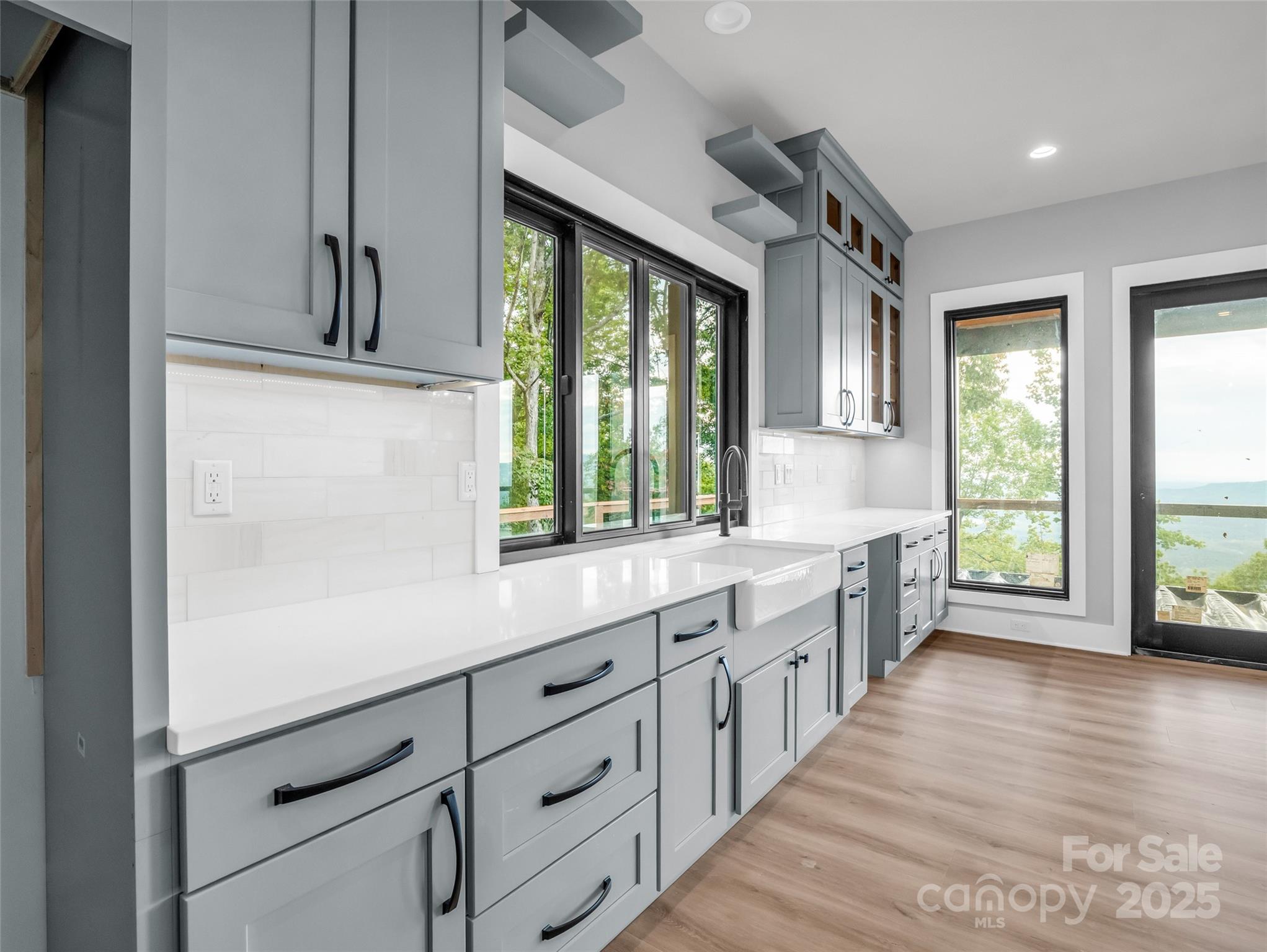 93 Chesterfield Drive Mill Spring, NC 28756 - Photo 12 of 48 a large white kitchen with granite countertop a large window