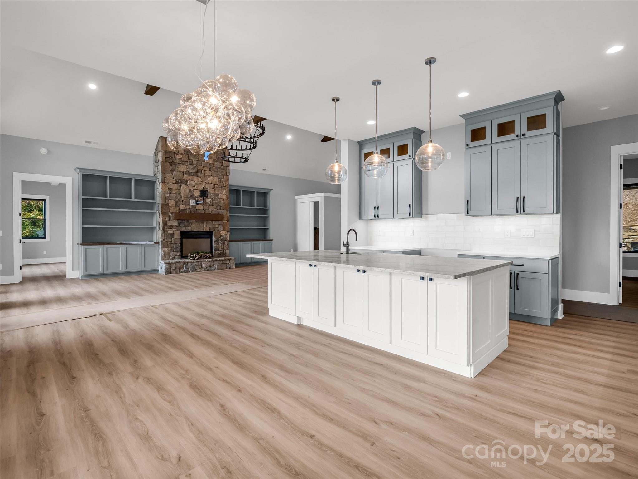 93 Chesterfield Drive Mill Spring, NC 28756 - Photo 14 of 48 a large kitchen with kitchen island a chandelier and living room view
