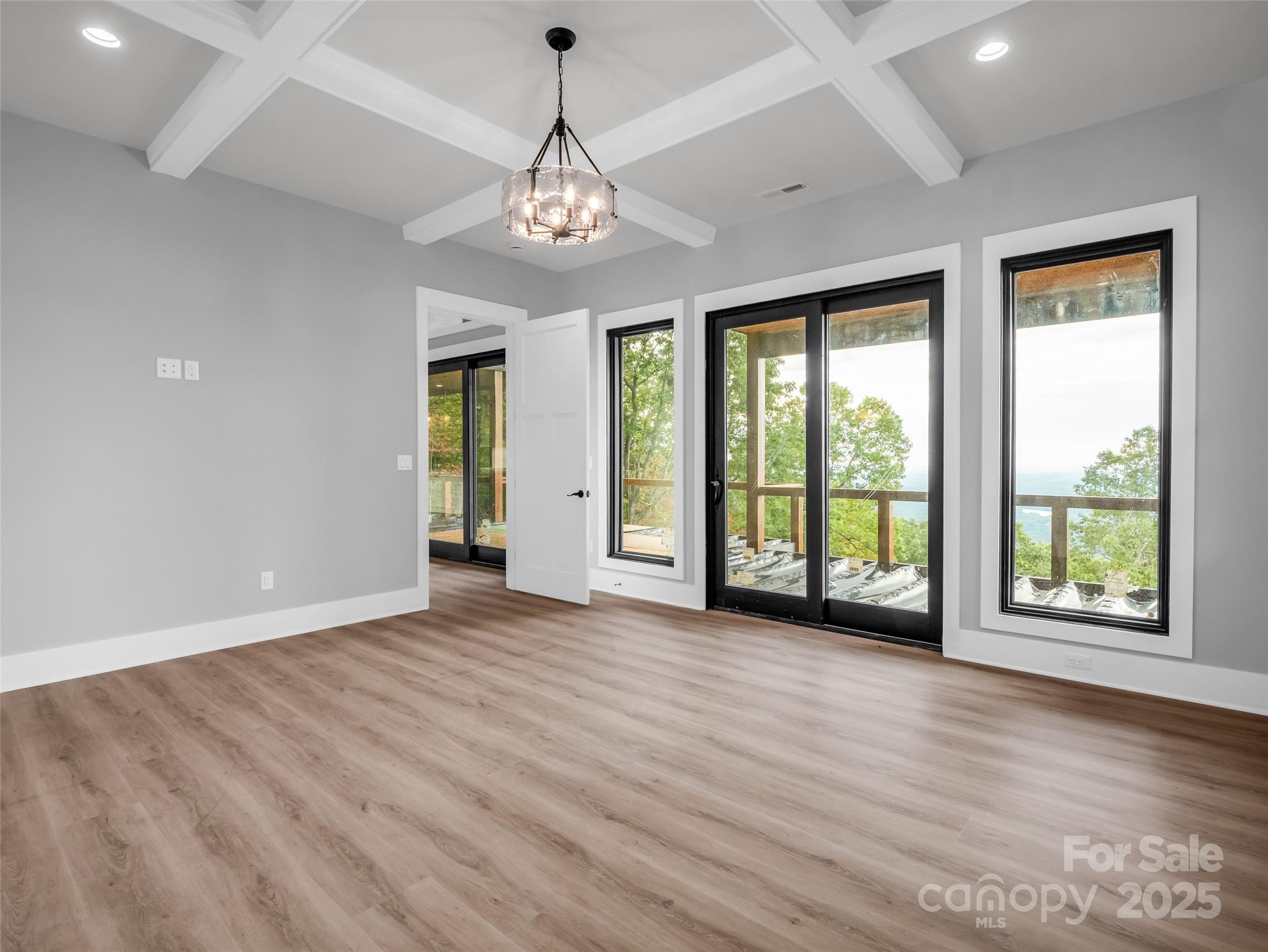 93 Chesterfield Drive Mill Spring, NC 28756 - Photo 17 of 48 a view of an empty room with wooden floor and a window
