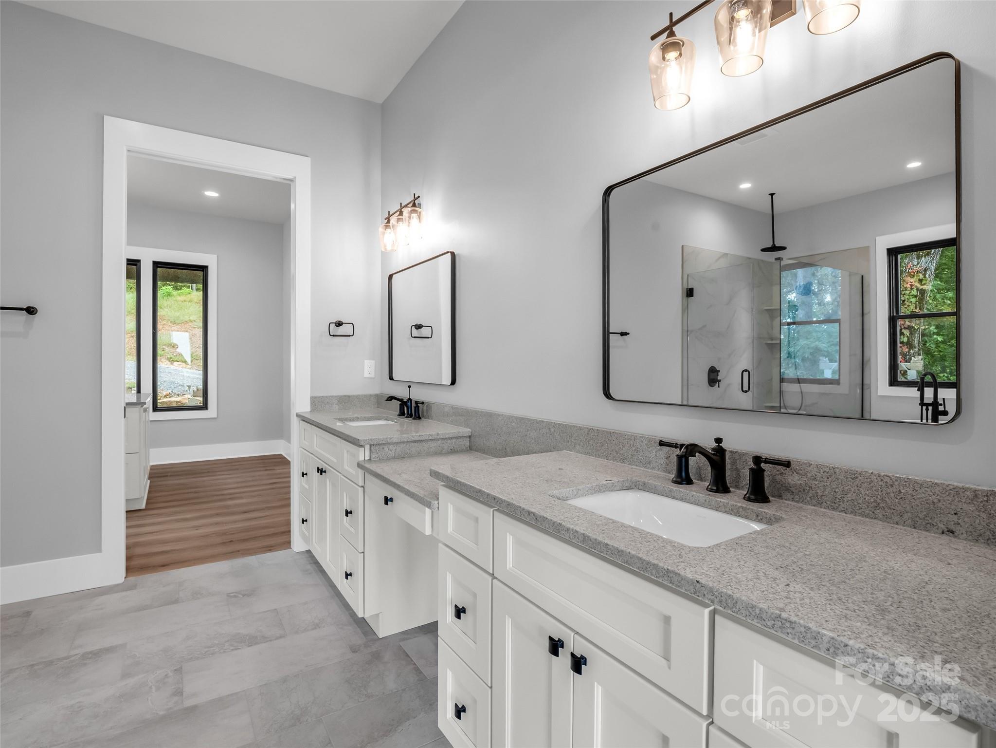 93 Chesterfield Drive Mill Spring, NC 28756 - Photo 18 of 48 a bathroom with 2 sink and a mirror