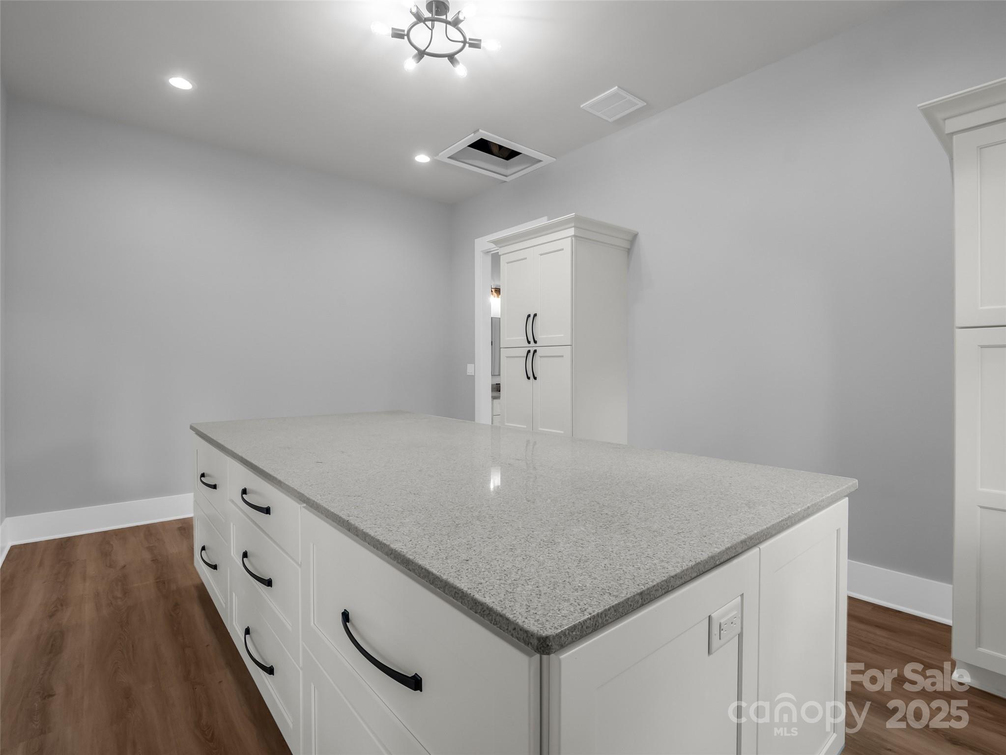 93 Chesterfield Drive Mill Spring, NC 28756 - Photo 22 of 48 a kitchen with a sink two chairs and cabinets