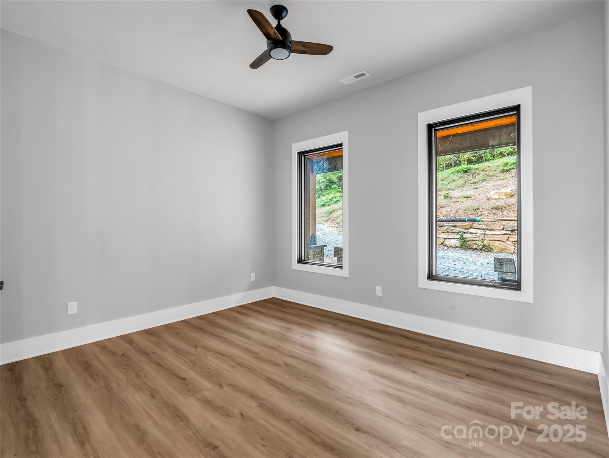 93 Chesterfield Drive Mill Spring, NC 28756 - Photo 27 of 48 a view of an empty room with wooden floor and a window