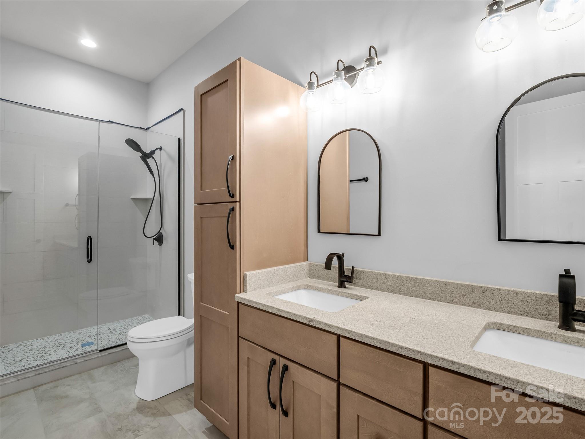 93 Chesterfield Drive Mill Spring, NC 28756 - Photo 29 of 48 a bathroom with a double vanity sink toilet and shower