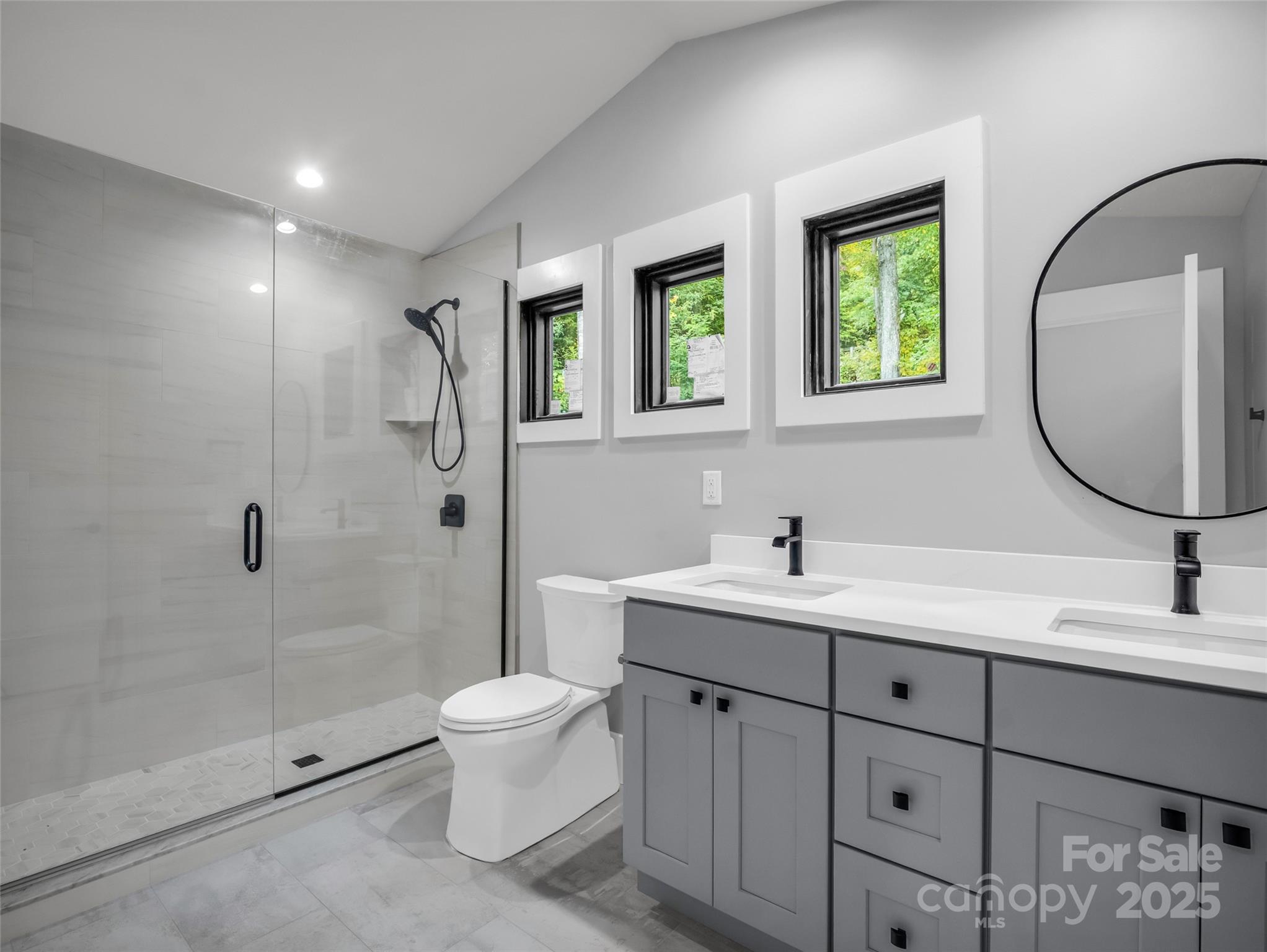93 Chesterfield Drive Mill Spring, NC 28756 - Photo 32 of 48 a bathroom with a toilet a sink a mirror and a shower