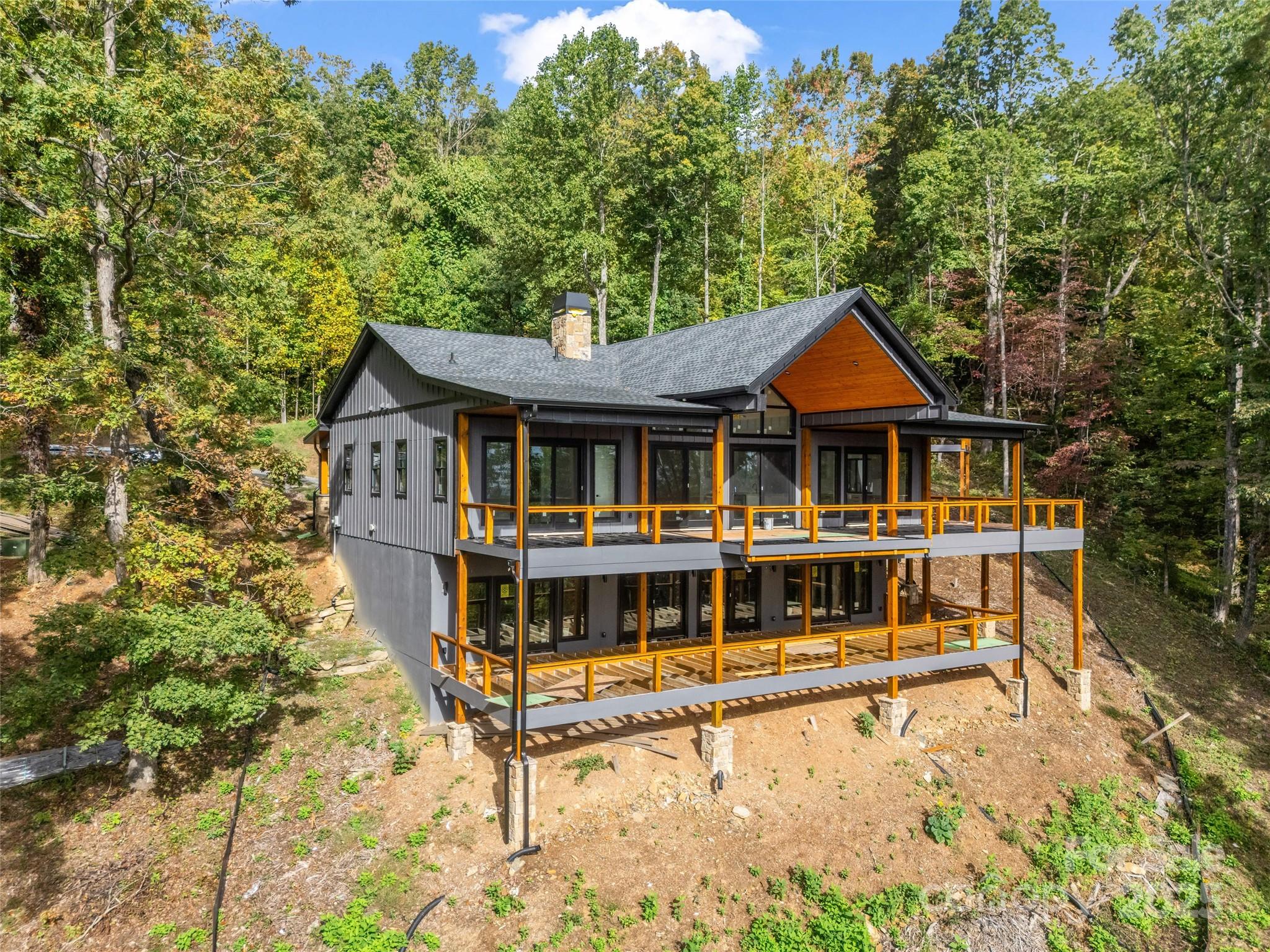 93 Chesterfield Drive Mill Spring, NC 28756 - Photo 42 of 48 a front view of a house with a yard table and chairs