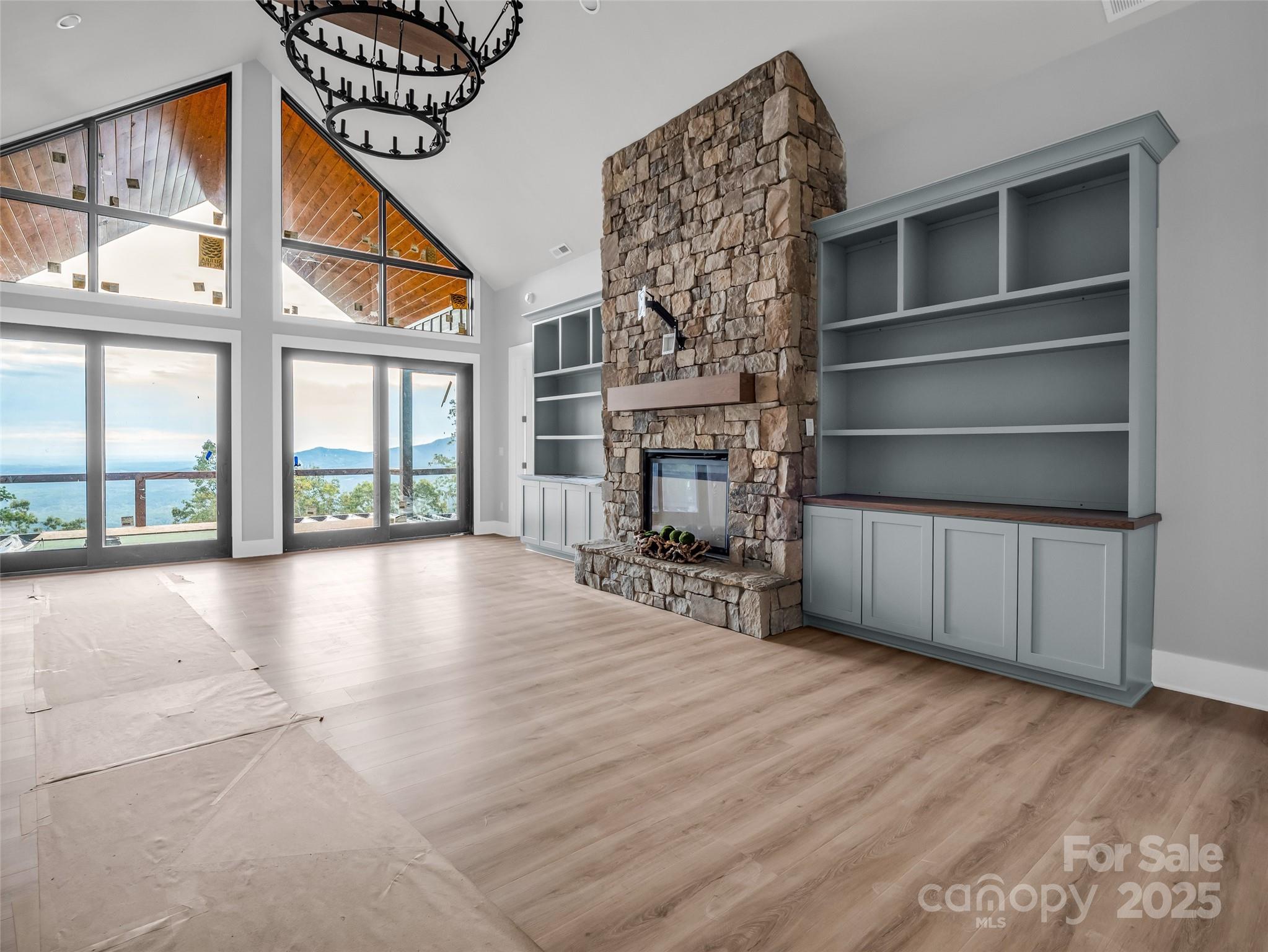93 Chesterfield Drive Mill Spring, NC 28756 - Photo 6 of 48 a view of an empty room with wooden floor and a fireplace