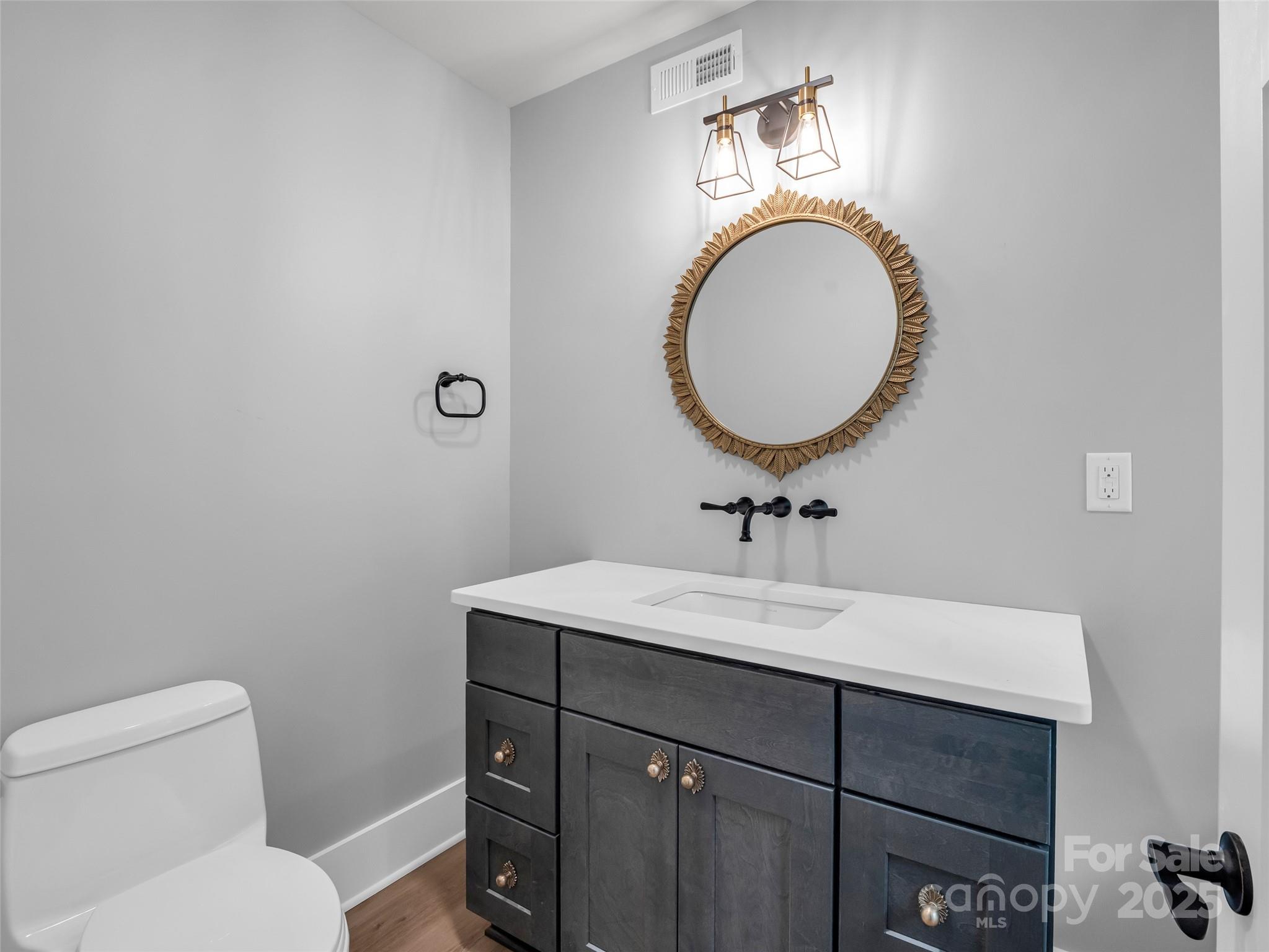 93 Chesterfield Drive Mill Spring, NC 28756 - Photo 8 of 48 a bathroom with a toilet a sink and a mirror