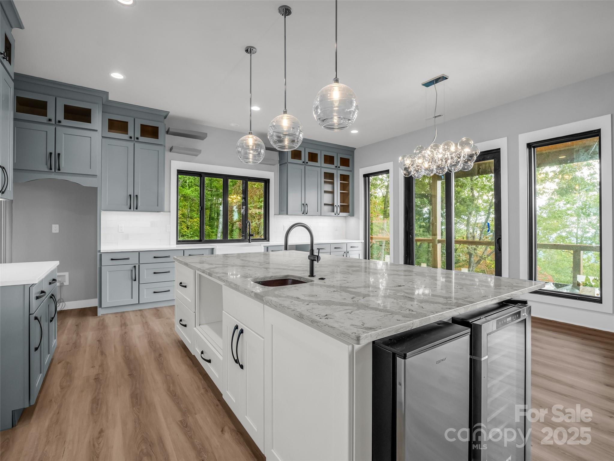 93 Chesterfield Drive Mill Spring, NC 28756 - Photo 10 of 48 a kitchen with kitchen island granite countertop a stove a sink a oven and a large window
