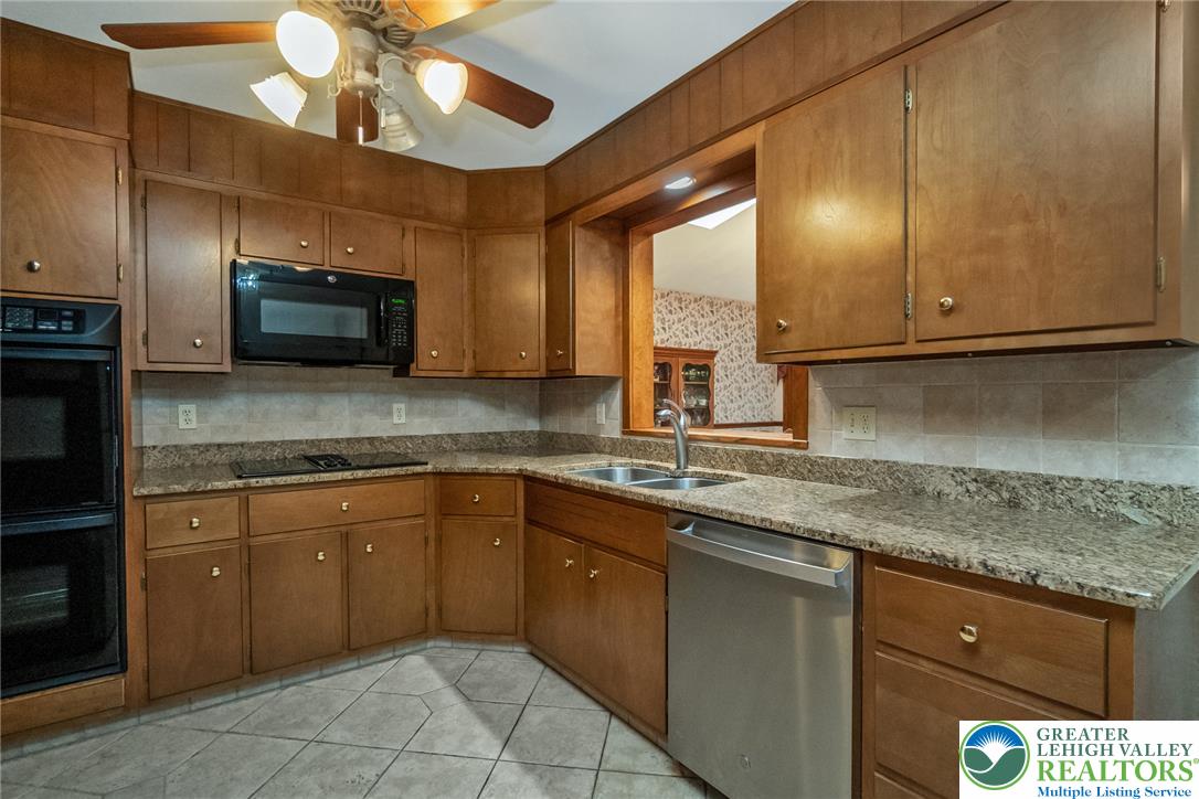 1328 Russett Road Allentown, PA 18104 - Photo 11 of 46 A well-appointed kitchen features ample cabinetry and a pass-through window.