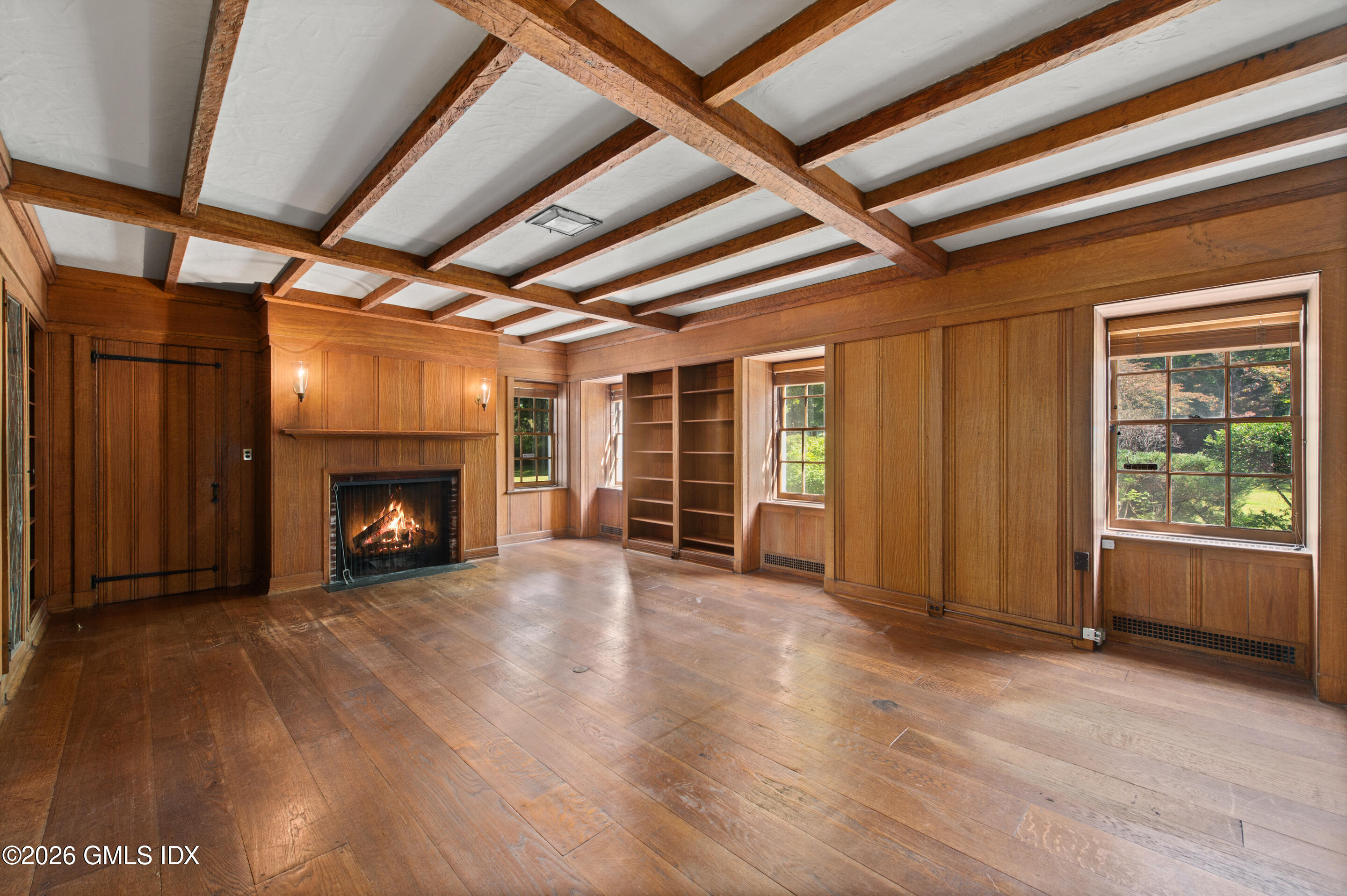 122 Round Hill Road Greenwich, CT 06831 - Photo 13 of 37 a view of an empty room with a fireplace and a window