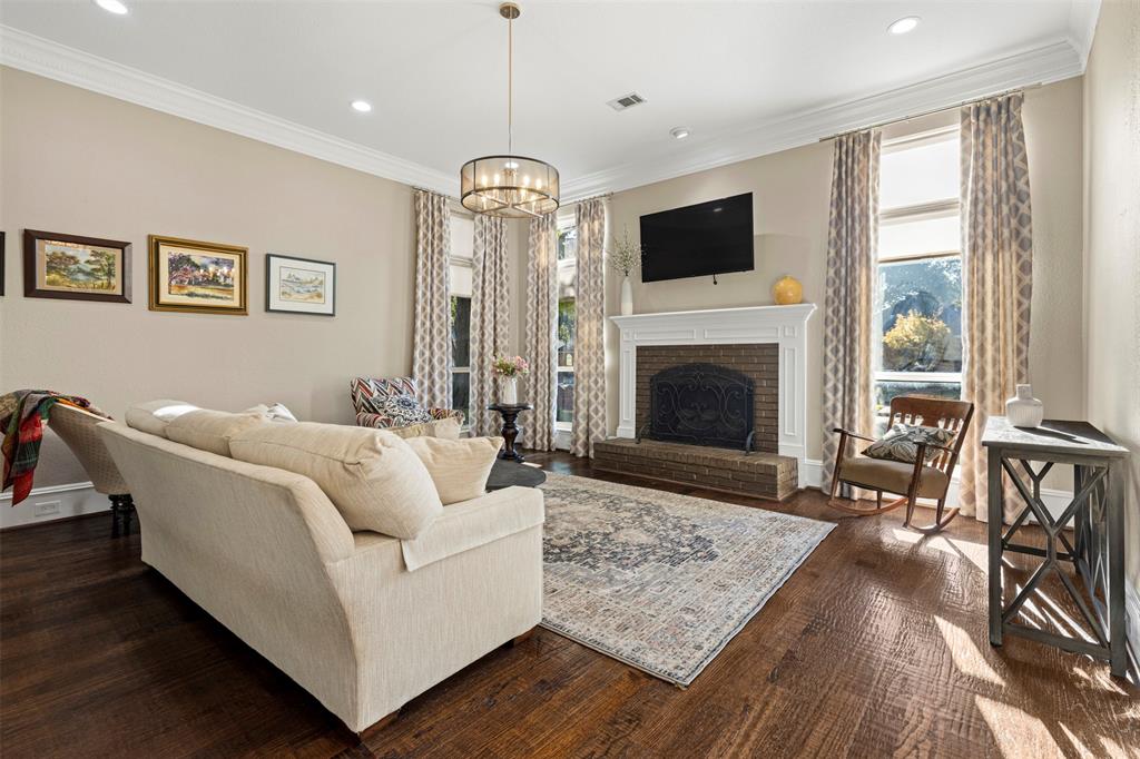 6306 Chelsea Way Garland, TX 75044 - Photo 2 of 37 Living area with handscraped wood floors, a brick fireplace, healthy amount of natural light