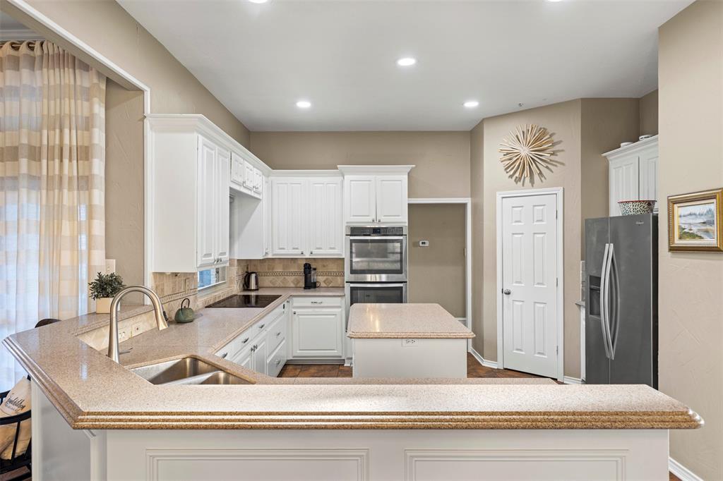 6306 Chelsea Way Garland, TX 75044 - Photo 8 of 37 Kitchen with granite countertops, white cabinets