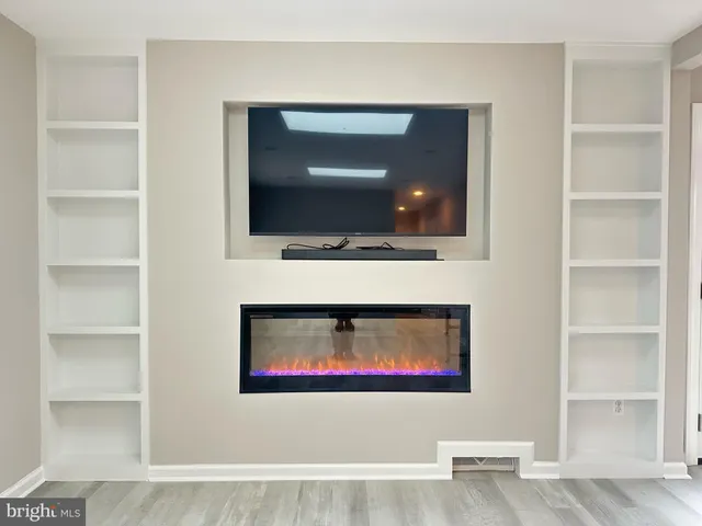 a living room with a flat screen tv and a fireplace