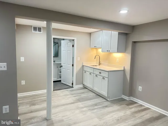 a spacious bathroom with a granite countertop sink and mirror