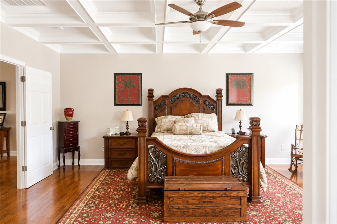 190 Fred Bradford Road Iva, SC 29655 - Photo 16 of 32 This spacious bedroom features a beautiful coffered ceiling and hardwood floors, offering a serene retreat.