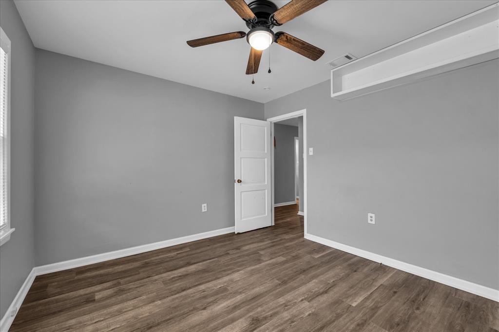 1325 Sunset Street Waco, TX 76710 - Photo 23 of 40 Unfurnished room with dark wood-style floors and a ceiling fan