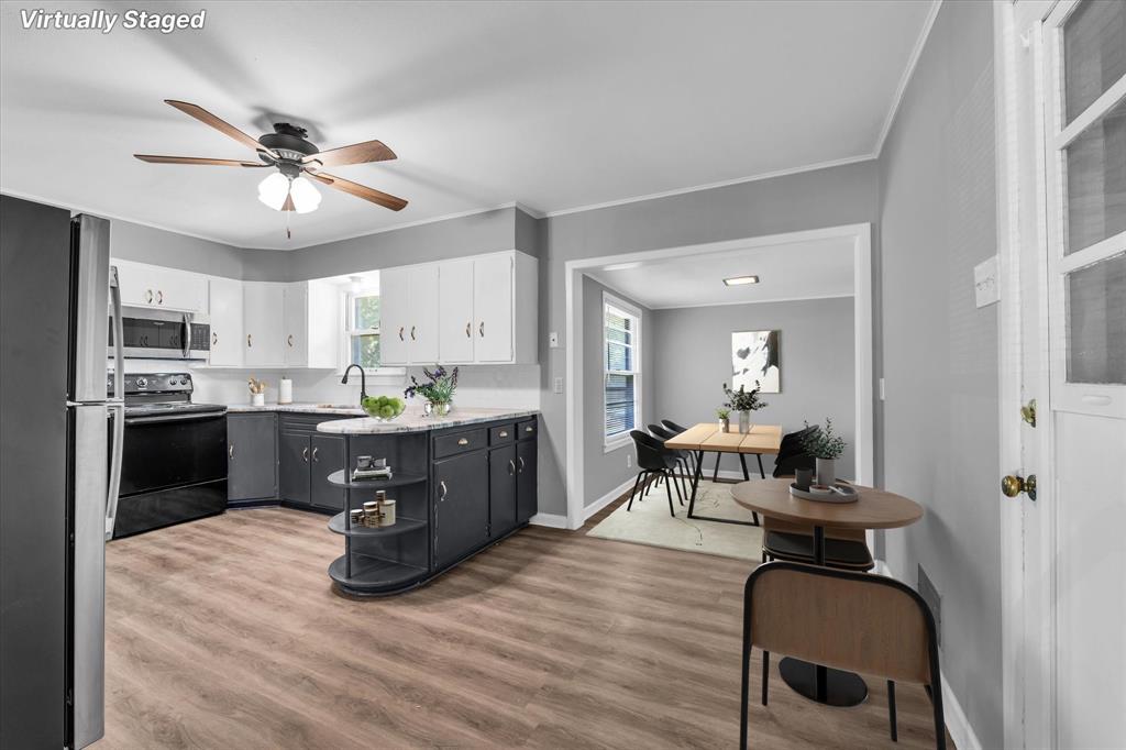 1325 Sunset Street Waco, TX 76710 - Photo 5 of 40 Kitchen featuring appliances with stainless steel finishes, light wood-style flooring, white cabinetry, ceiling fan, and crown molding