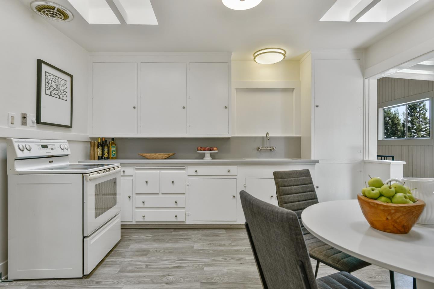 132 Alta Vista Road Woodside, CA 94062 - Photo 14 of 44 a kitchen with stainless steel appliances granite countertop a sink and white cabinets