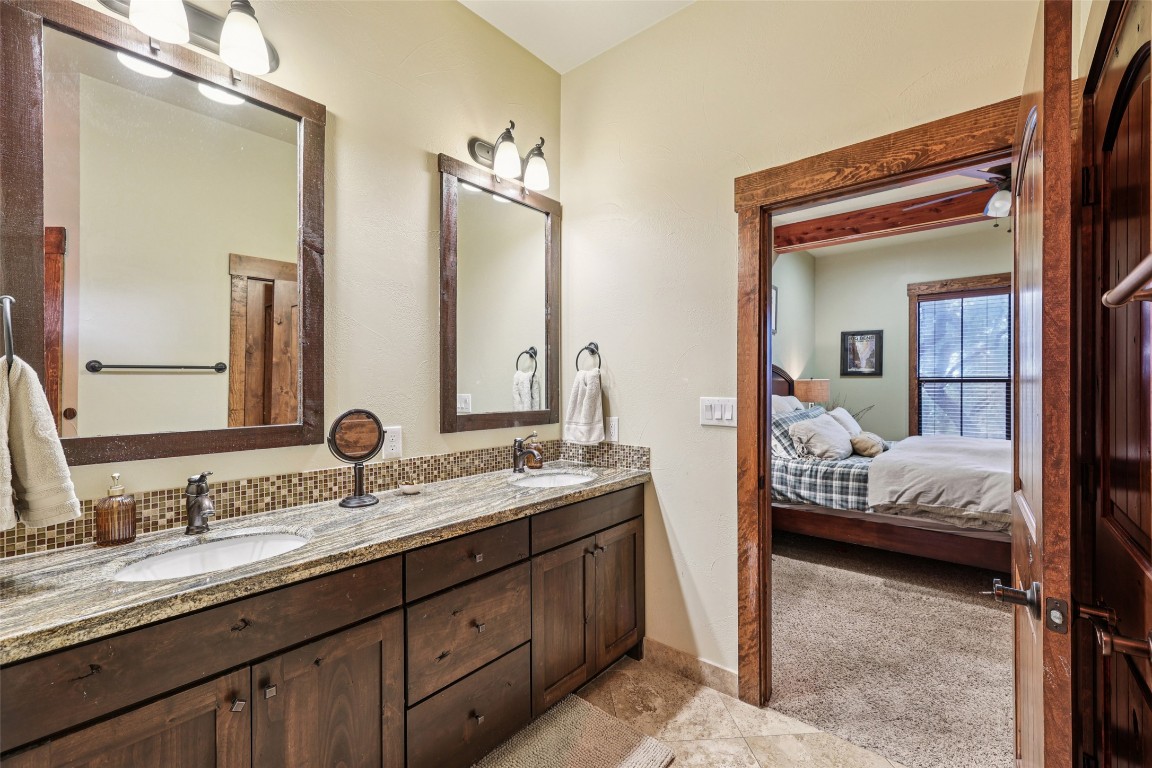 7229 Trident Jonestown, TX 78645 - Photo 14 of 34 a en suite bathroom with double vanity sinks and a mirror