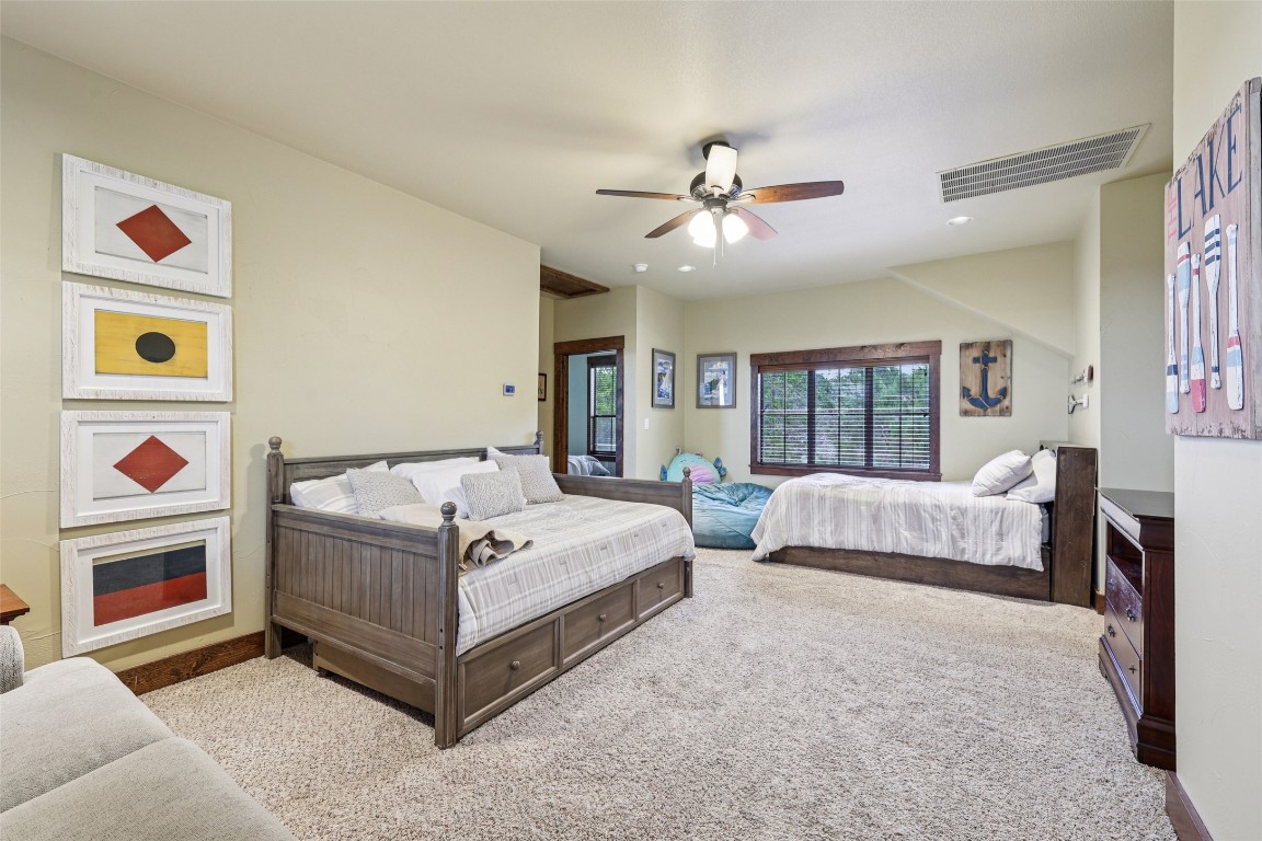 7229 Trident Jonestown, TX 78645 - Photo 17 of 34 a spacious bedroom with a bed and a large window
