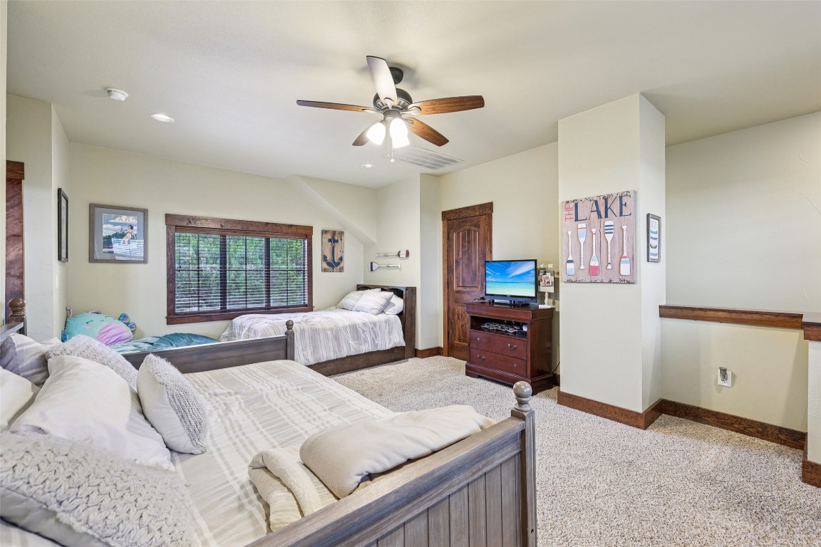 7229 Trident Jonestown, TX 78645 - Photo 18 of 34 a bedroom with a bed and furniture