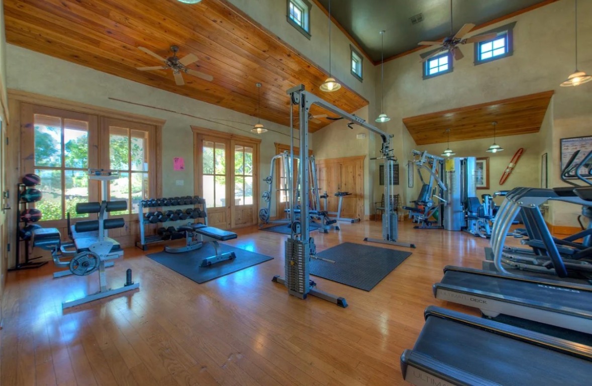 7229 Trident Jonestown, TX 78645 - Photo 32 of 34 a living room with fireplace furniture and a large window