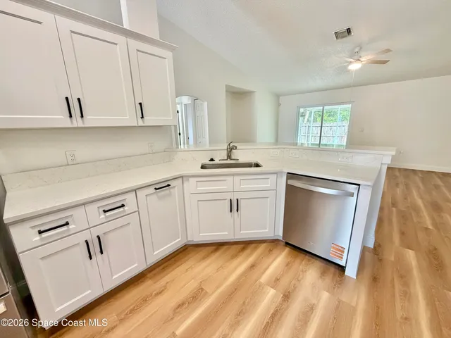 a kitchen with stainless steel appliances a stove microwave and sink