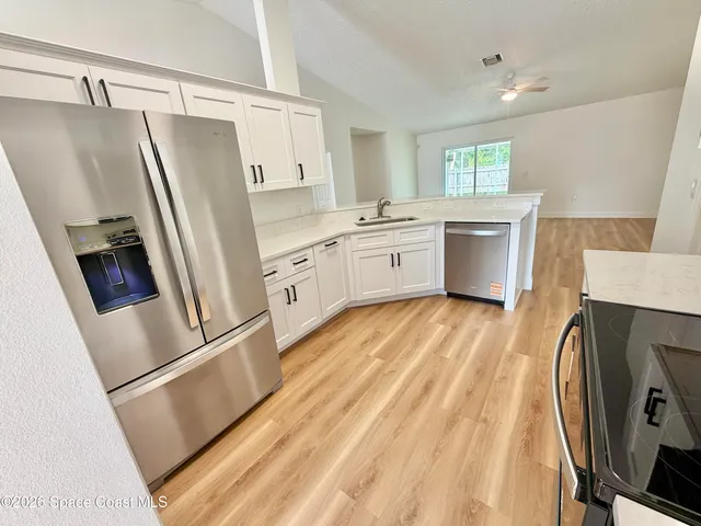 a kitchen with stainless steel appliances a stove microwave and cabinets