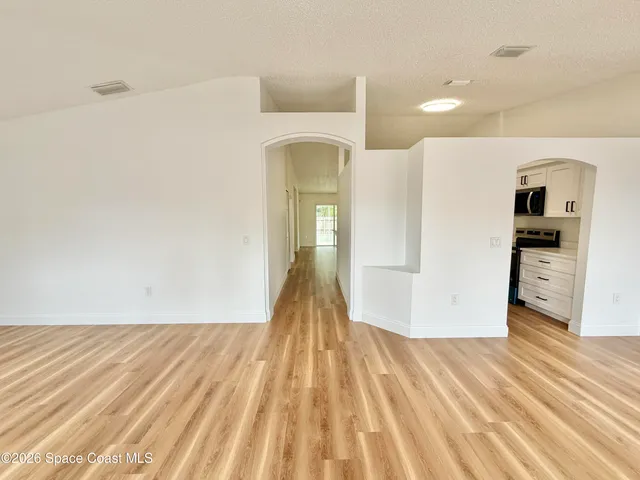 a bathroom with double vanity and a mirror
