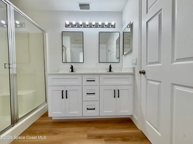 a view of empty room with wooden floor