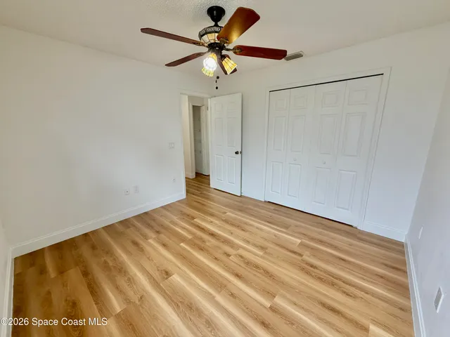 a view of a hallway view with wooden floor and staircase