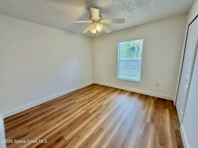 a view of a house with a yard and potted plants