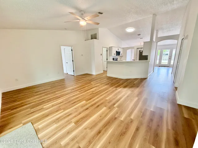 a view of a room with wooden floor and staircase