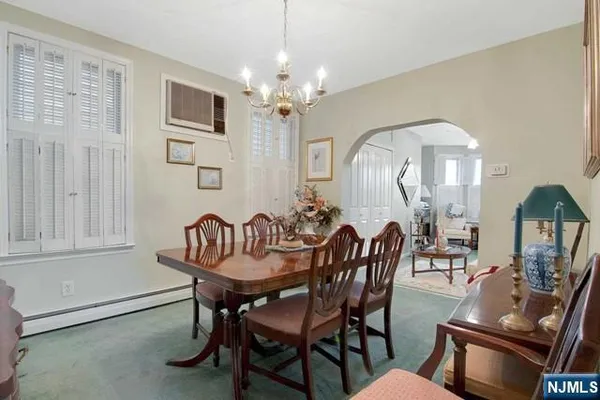 a view of a dining room with furniture and chandelier