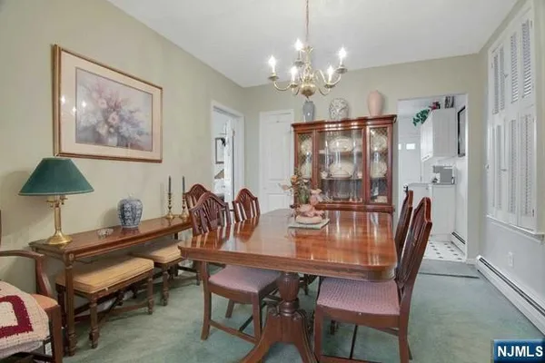 a view of a dining room with furniture and chandelier
