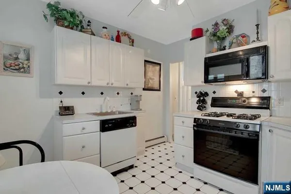 a kitchen with stainless steel appliances a stove a microwave and cabinets