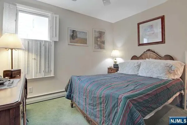 a bedroom with a bed and a lamp on table