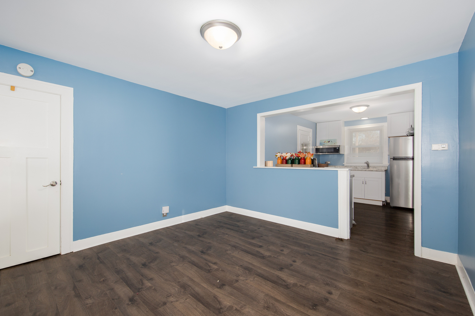 718 Clinton Street Lockport, IL 60441 - Photo 4 of 15 a view of a kitchen with wooden floor and a kitchen