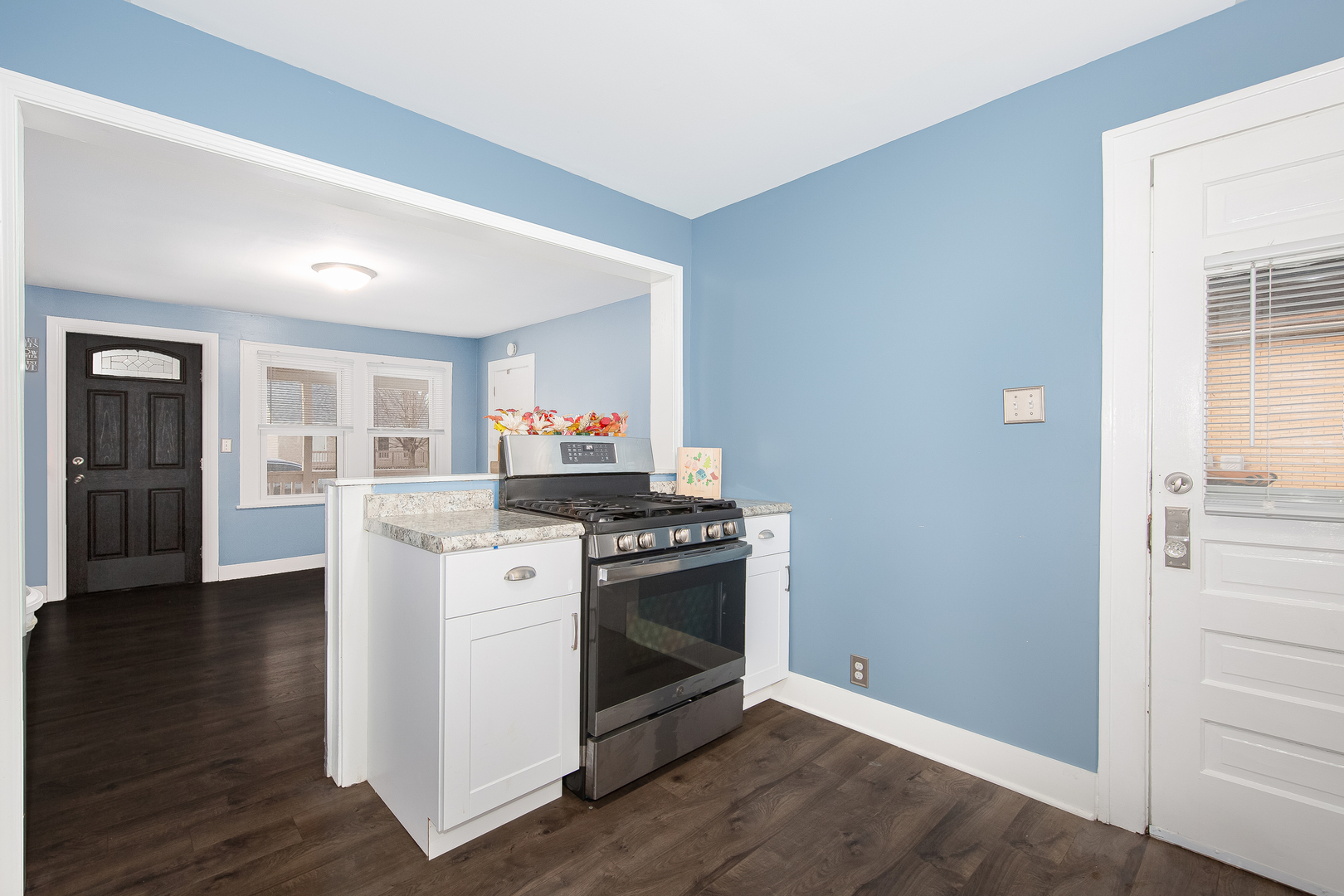 718 Clinton Street Lockport, IL 60441 - Photo 5 of 15 a kitchen with a stove and wooden floor