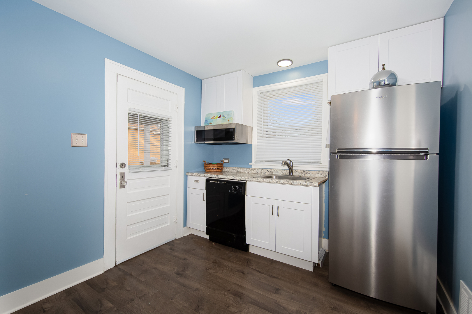 718 Clinton Street Lockport, IL 60441 - Photo 6 of 15 a kitchen with white cabinets and white appliances