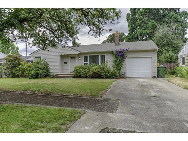 a view of a house with yard and a garden
