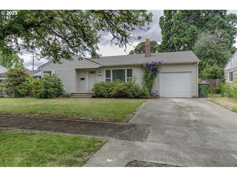 a view of a house with yard and a garden