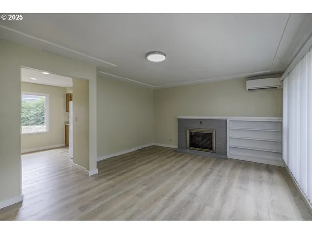 a view of an empty room with a fireplace