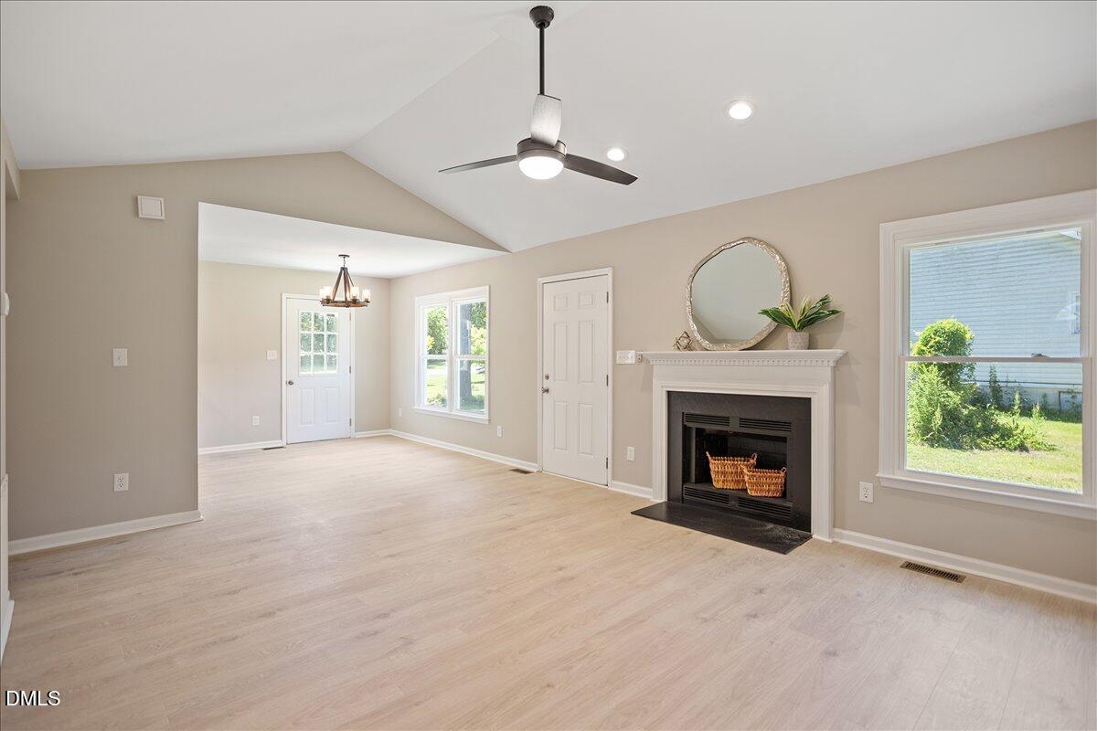31 Fieldview Court Angier, NC 27501 - Photo 2 of 25 a view of empty room with fireplace and wooden floor