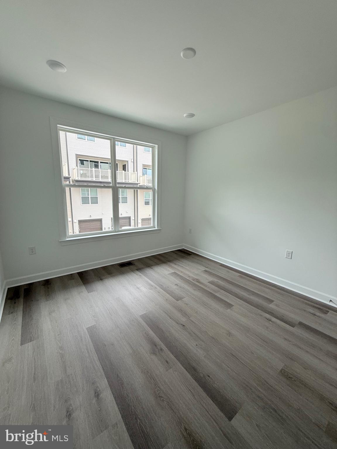 4900 Chelan Crossing Chantilly, VA 20151 - Photo 22 of 27 an empty room with wooden floor and windows