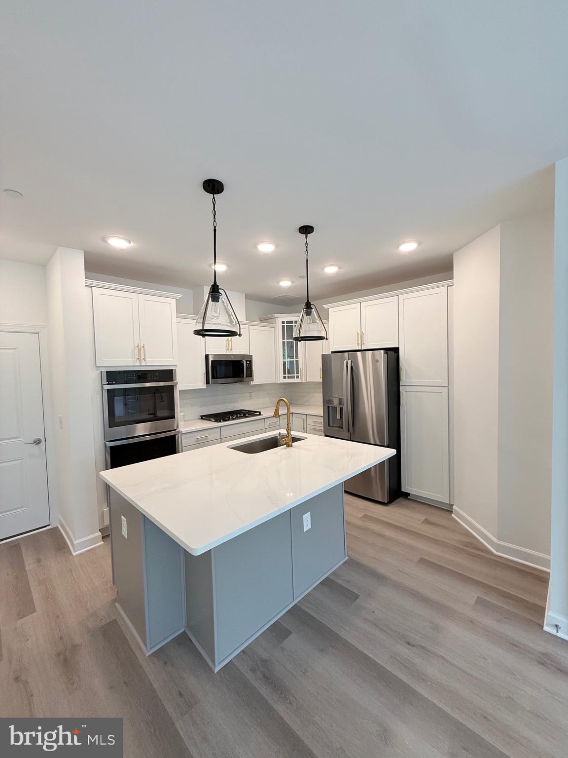 4900 Chelan Crossing Chantilly, VA 20151 - Photo 6 of 27 a large kitchen with kitchen island a stove a sink a refrigerator and a refrigerator