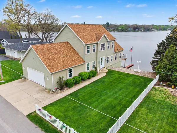 a view of house with garden and lake view